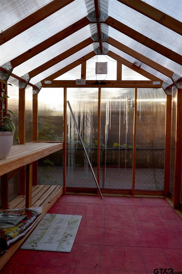 unfurnished sunroom with lofted ceiling