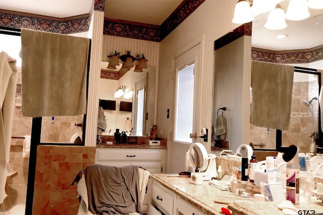 bathroom with a shower with door and vanity