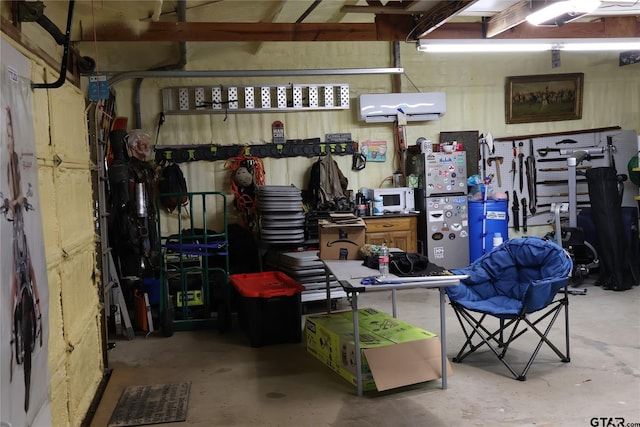 garage featuring a wall mounted AC and a workshop area