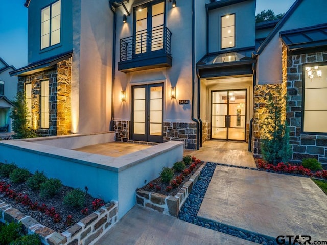 2424 Bellview Cir, Tyler, TX 75709 - entrance to property featuring french doors, stucco siding, stone siding, and a balcony