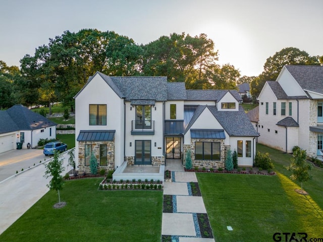 2424 Bellview Cir, Tyler, TX 75709 - modern farmhouse featuring french doors, a balcony, a standing seam roof, and a front yard