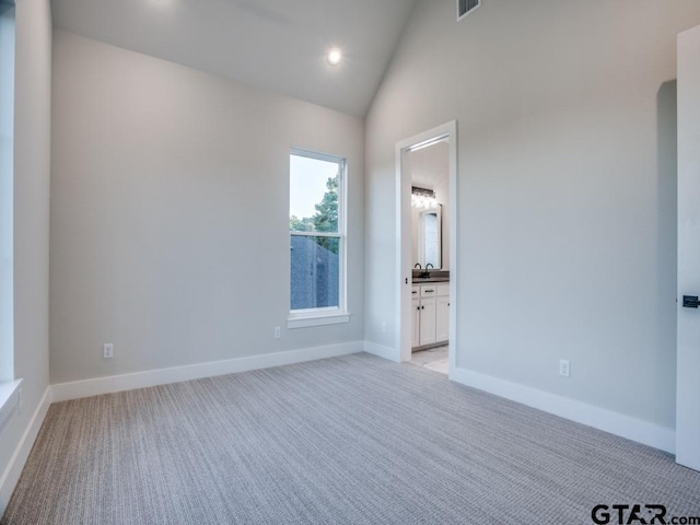 2424 Bellview Cir, Tyler, TX 75709 - empty room featuring light carpet, recessed lighting, and high vaulted ceiling