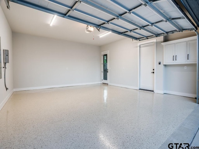 2424 Bellview Cir, Tyler, TX 75709 - garage with a garage door opener and baseboards