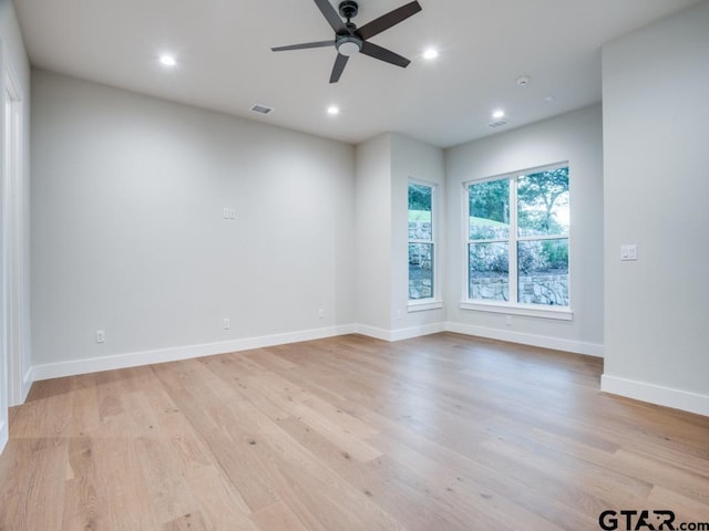 spare room featuring light wood-type flooring and ceiling fan