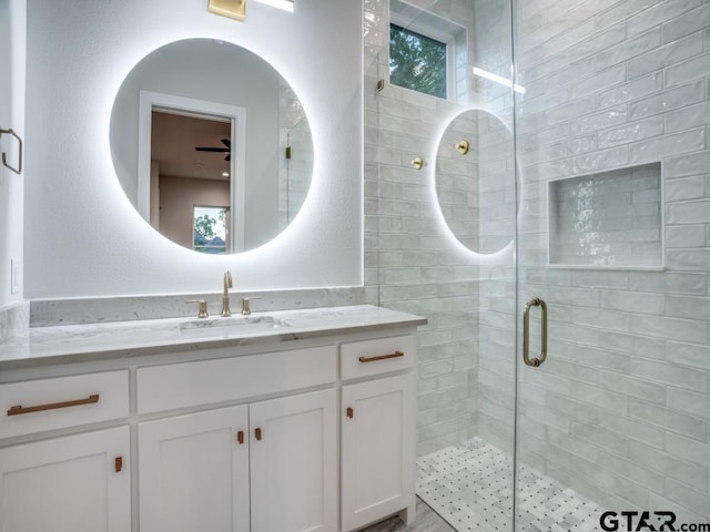 bathroom with walk in shower and vanity