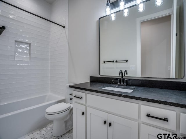 full bathroom with tile patterned flooring, vanity, tiled shower / bath combo, and toilet