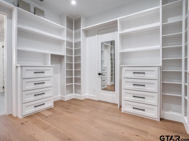 spacious closet with light hardwood / wood-style floors