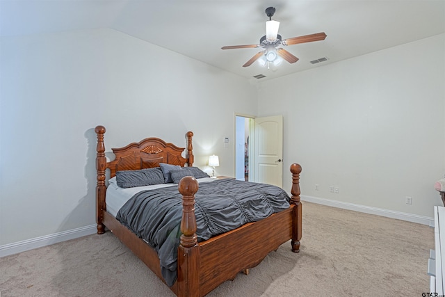 carpeted bedroom featuring ceiling fan and vaulted ceiling