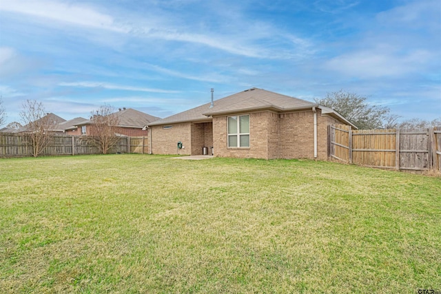 back of property with a yard and a patio