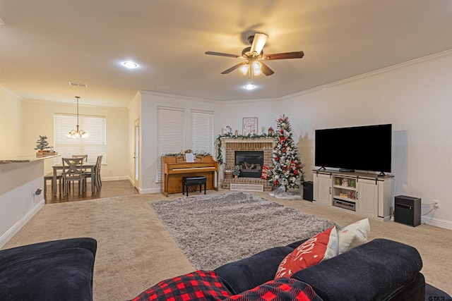 living room featuring a brick fireplace, light carpet, ceiling fan with notable chandelier, and ornamental molding