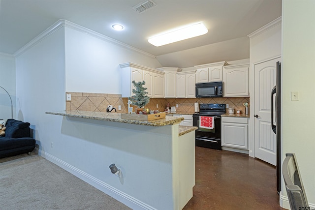 kitchen with black appliances, white cabinetry, light stone countertops, and kitchen peninsula