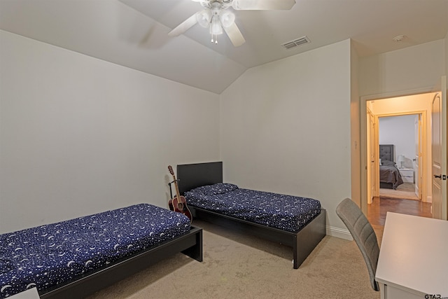 bedroom with light colored carpet, ceiling fan, and lofted ceiling