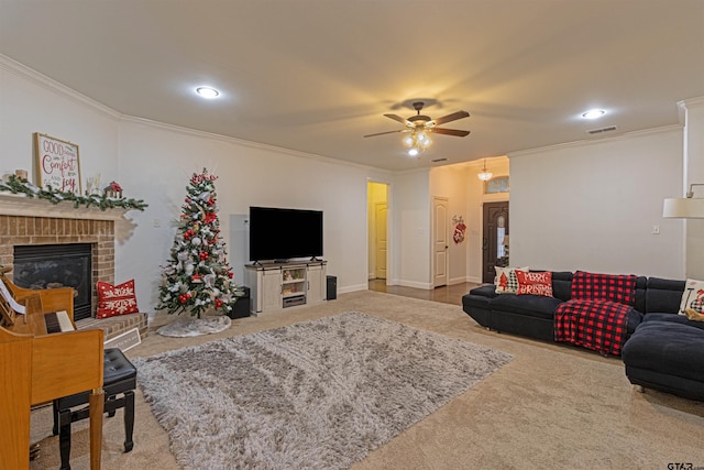 carpeted living room featuring a fireplace, ceiling fan, and ornamental molding