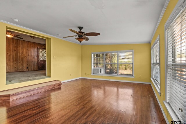 unfurnished living room with ceiling fan, hardwood / wood-style floors, and ornamental molding