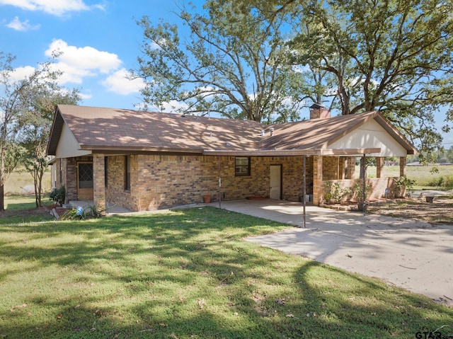 ranch-style home with a front yard and a patio