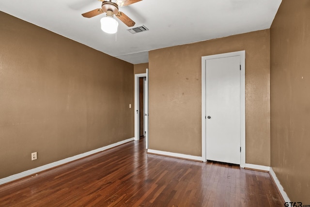 spare room with ceiling fan and dark hardwood / wood-style flooring