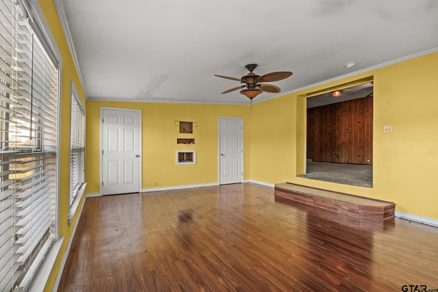 unfurnished living room featuring ornamental molding, wood-type flooring, and ceiling fan