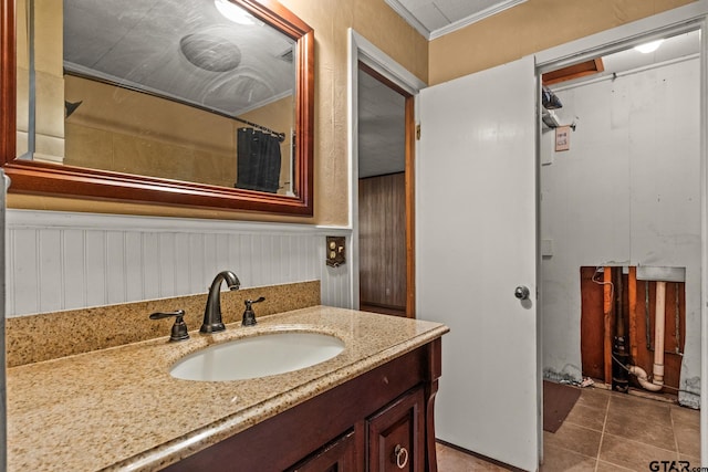 bathroom featuring vanity, tile patterned floors, and ornamental molding