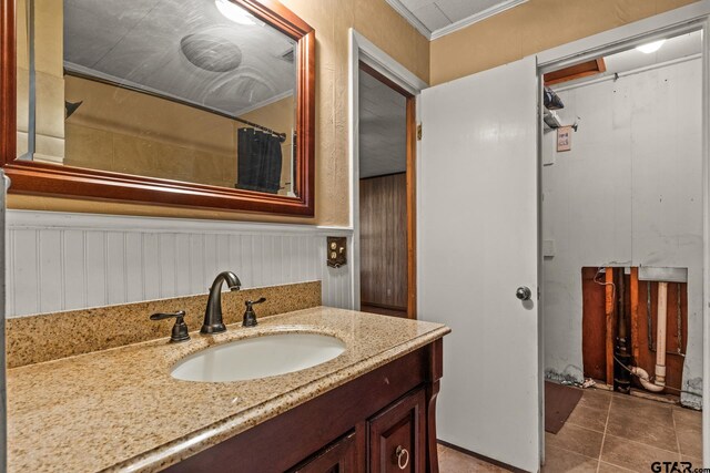 bathroom featuring vanity, tile patterned floors, and ornamental molding