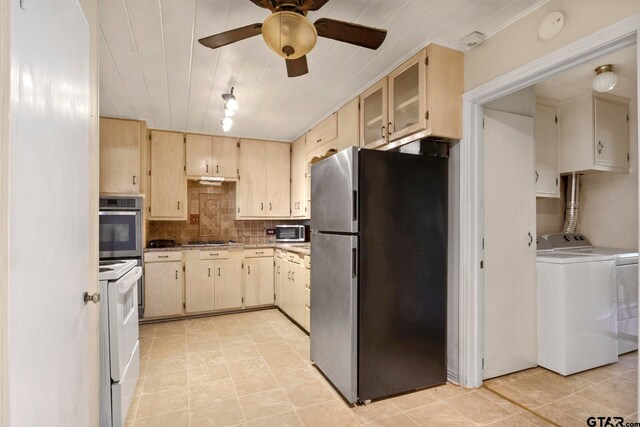 kitchen featuring separate washer and dryer, appliances with stainless steel finishes, light tile patterned floors, decorative backsplash, and ceiling fan