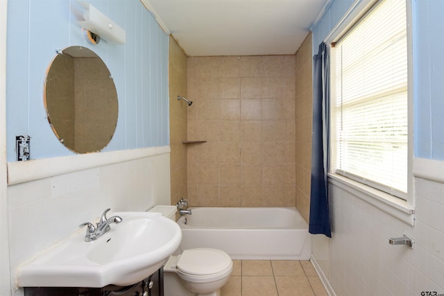 full bathroom featuring sink, plenty of natural light, tile patterned floors, and tile walls