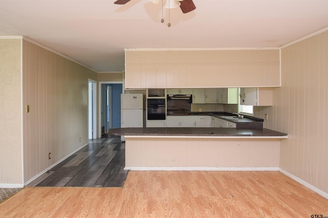 kitchen with white cabinetry, kitchen peninsula, and light hardwood / wood-style floors