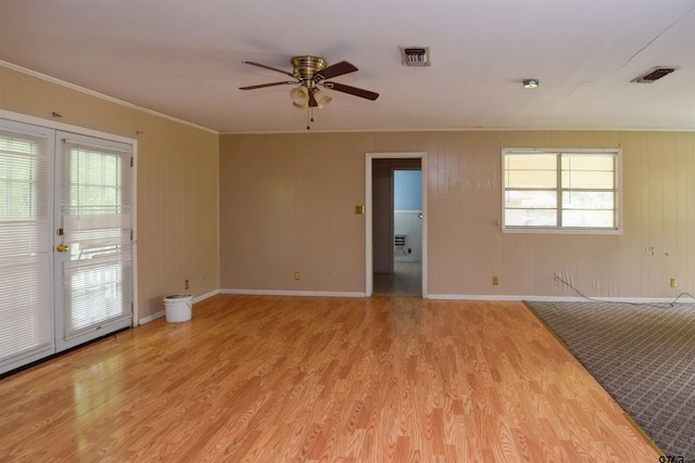 spare room with ceiling fan, light hardwood / wood-style flooring, french doors, and ornamental molding