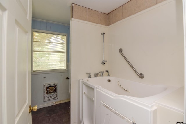 bathroom with ornamental molding, a bathtub, tile patterned floors, and heating unit