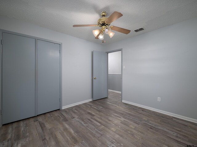 bathroom with hardwood / wood-style flooring, a shower with door, a textured ceiling, and vanity