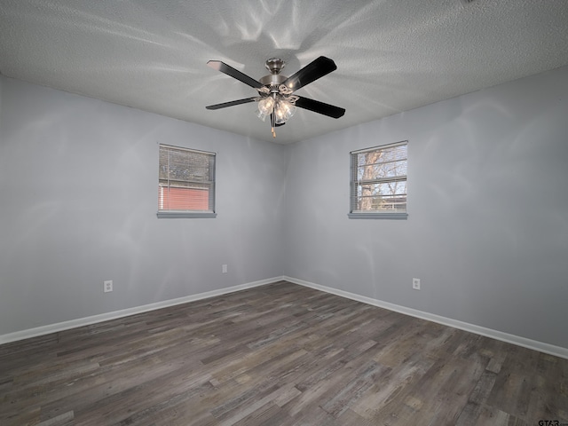 unfurnished room with ceiling fan, a textured ceiling, and dark hardwood / wood-style flooring