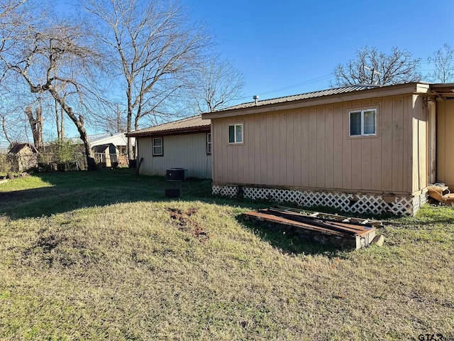 exterior space featuring cooling unit and a lawn