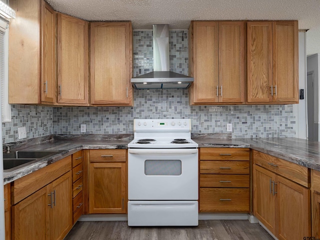 kitchen featuring hardwood / wood-style flooring, backsplash, wall chimney range hood, and white electric range