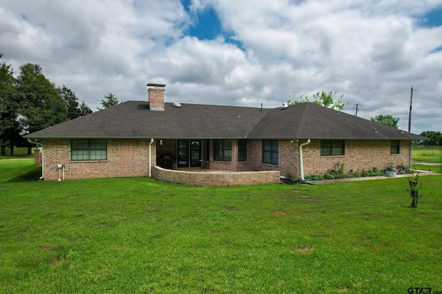 view of front of home with a patio area and a front yard