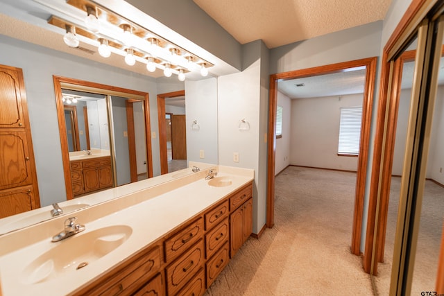 bathroom with vanity and a textured ceiling