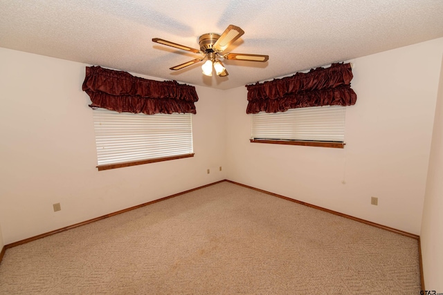 carpeted empty room featuring a textured ceiling and ceiling fan