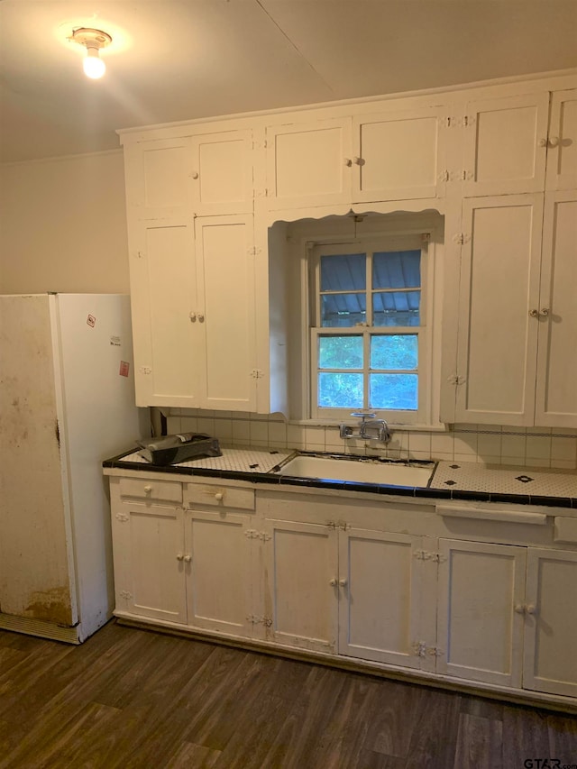 kitchen featuring white cabinetry, white refrigerator, sink, and dark hardwood / wood-style floors