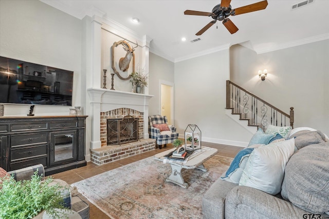523 Southcreek Dr, Chandler, TX 75758 - tiled living room with a ceiling fan, ornamental molding, a brick fireplace, stairs, and baseboards