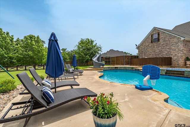 523 Southcreek Dr, Chandler, TX 75758 - view of pool featuring a water slide, a fenced backyard, a patio, and a pool with connected hot tub