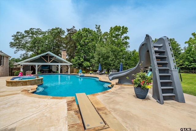 523 Southcreek Dr, Chandler, TX 75758 - view of pool with a water slide, a patio area, fence, a gazebo, and a pool with connected hot tub