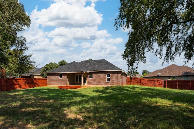 rear view of house with a yard