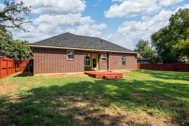 rear view of house with central AC, a yard, and a wooden deck