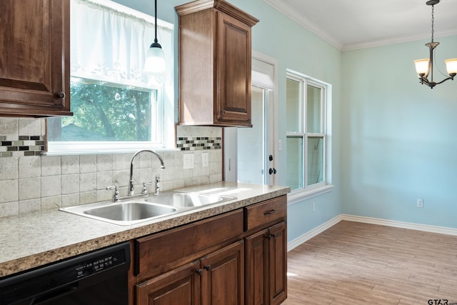 kitchen with sink, ornamental molding, decorative light fixtures, light wood-type flooring, and black dishwasher