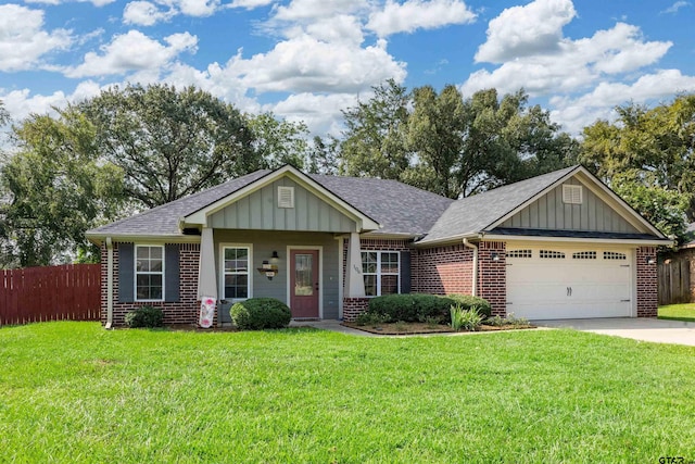 craftsman house featuring a garage and a front lawn