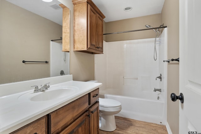 full bathroom with washtub / shower combination, wood-type flooring, toilet, and vanity