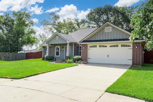 view of front of property featuring a garage and a front lawn