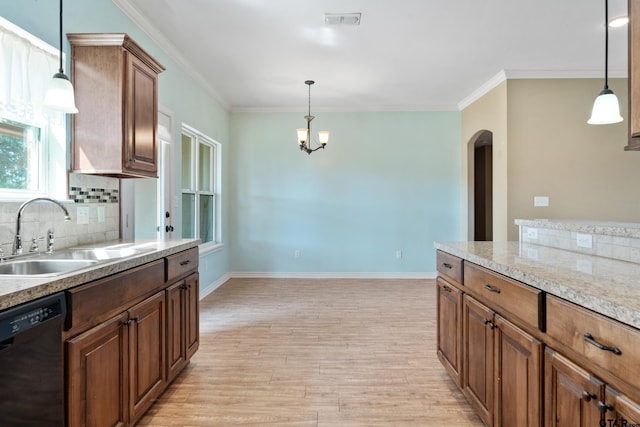 kitchen with crown molding, light wood-type flooring, decorative light fixtures, black dishwasher, and sink