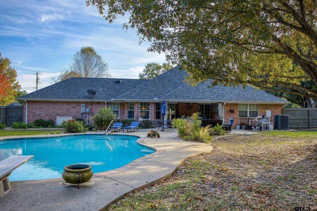 view of pool with a diving board, central air condition unit, and a patio