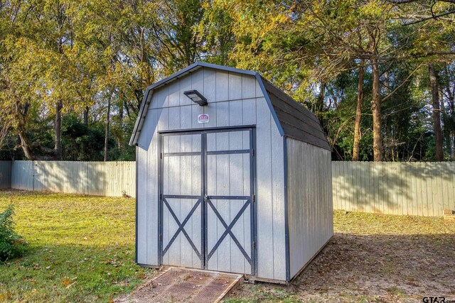 view of outbuilding featuring a lawn