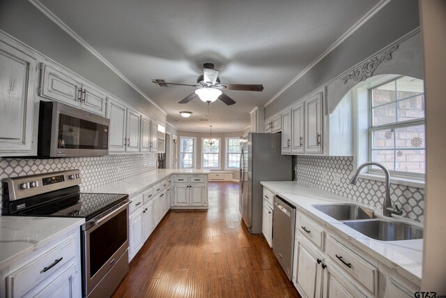 kitchen featuring decorative backsplash, white cabinetry, sink, and stainless steel appliances