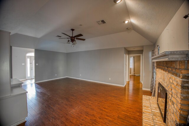 unfurnished living room with a fireplace, hardwood / wood-style floors, a textured ceiling, and ceiling fan